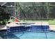 Relaxing jacuzzi inside screened enclosure next to a lush landscaped outdoor area at 4049 Wellington Pkwy, Palm Harbor, FL 34685