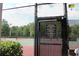 Tennis court access gate with rules and key required for entry, ensuring controlled and secure access at 4049 Wellington Pkwy, Palm Harbor, FL 34685