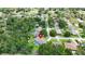 Neighborhood aerial view features a cozy home with a screened-in pool nestled among trees at 414 Summit Chase Dr, Valrico, FL 33594
