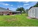 Expansive backyard with a screened pool area, manicured lawn and a convenient storage shed at 414 Summit Chase Dr, Valrico, FL 33594