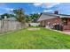 Spacious backyard with brick feature and lush green lawn, enhanced by a sturdy perimeter fence at 414 Summit Chase Dr, Valrico, FL 33594