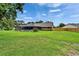 Large backyard with mature trees, manicured lawn, and a screened-in pool area is perfect for outdoor living at 414 Summit Chase Dr, Valrico, FL 33594