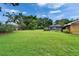 Expansive backyard with lush green lawn, screened pool, and mature trees offers privacy at 414 Summit Chase Dr, Valrico, FL 33594