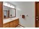 This bathroom features a large mirror, a sink, and wooden fixtures at 414 Summit Chase Dr, Valrico, FL 33594