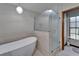 Modern soaking tub and walk-in shower in updated primary bathroom at 414 Summit Chase Dr, Valrico, FL 33594