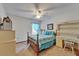 Cozy bedroom features a ceiling fan, a writing desk, and a double bed with blue bedding at 414 Summit Chase Dr, Valrico, FL 33594