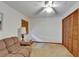 This carpeted room has a fan, a lamp, a small table, and a closet with wooden louvered doors at 414 Summit Chase Dr, Valrico, FL 33594