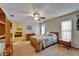 Bedroom with ceiling fan, area rug, side table, and door to the living room at 414 Summit Chase Dr, Valrico, FL 33594