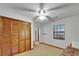 This bedroom features a large closet with wood louvered doors and a window at 414 Summit Chase Dr, Valrico, FL 33594