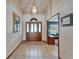 Inviting foyer with tiled floor and decorative wood and glass front door at 414 Summit Chase Dr, Valrico, FL 33594