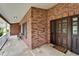 Elegant brick front entrance with a stylish dark wood door at 414 Summit Chase Dr, Valrico, FL 33594