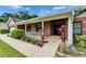 Inviting front porch featuring brick accents, white picket fence, and well-maintained landscaping at 414 Summit Chase Dr, Valrico, FL 33594