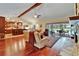 Open concept living area featuring a stone fireplace, hardwood floors, and access to the pool area at 414 Summit Chase Dr, Valrico, FL 33594
