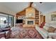 Spacious living room with a stone fireplace, built-in shelves, and access to a screened outdoor patio at 414 Summit Chase Dr, Valrico, FL 33594