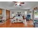Bright bedroom featuring wood flooring, ceiling fan, and sliding glass door to the lanai at 414 Summit Chase Dr, Valrico, FL 33594