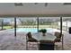Covered patio boasts a table and chairs with a view of the sparkling screened in pool at 414 Summit Chase Dr, Valrico, FL 33594