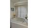 Soaking tub with tile surround, and large window with natural light in the bathroom at 4500 Onorio St, New Port Richey, FL 34653