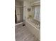Bathroom with soaking tub, tile surround, and shower in the background at 4500 Onorio St, New Port Richey, FL 34653