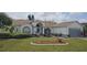 Charming single-story home with manicured lawn, garden beds, and an attached two-car garage at 4500 Onorio St, New Port Richey, FL 34653