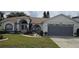 Charming single-story home featuring a well-manicured lawn, beautiful landscaping, and attached two-car garage at 4500 Onorio St, New Port Richey, FL 34653