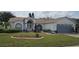 Charming single-story home with manicured lawn, garden beds, and an attached two-car garage at 4500 Onorio St, New Port Richey, FL 34653