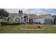 Charming single-story home with manicured lawn, garden beds, and an attached two-car garage at 4500 Onorio St, New Port Richey, FL 34653