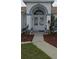 Beautiful home's front entrance with an arched doorway and manicured landscaping at 4500 Onorio St, New Port Richey, FL 34653