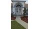 Beautiful home's front entrance with an arched doorway and manicured landscaping at 4500 Onorio St, New Port Richey, FL 34653