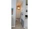 Bright hallway featuring a decorative chandelier and wood-look flooring leading to a closet at 4500 Onorio St, New Port Richey, FL 34653