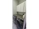 Laundry room featuring side-by-side washer and dryer with white cabinets above at 4500 Onorio St, New Port Richey, FL 34653