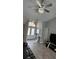 Bright and modern living room with light grey walls and grey vinyl floors featuring elegant light fixture at 4500 Onorio St, New Port Richey, FL 34653