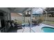Enjoy the outdoors with this patio featuring dining table and lounge furniture in a screened enclosure at 4500 Onorio St, New Port Richey, FL 34653