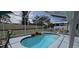Sparkling pool with screened enclosure, landscaping, and a rock waterfall feature at 4500 Onorio St, New Port Richey, FL 34653