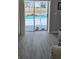 View of the pool area from indoors through sliding glass doors and overlooking modern flooring at 4500 Onorio St, New Port Richey, FL 34653