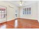 This bedroom features hardwood floors, white trim, and doors that lead to an outdoor area at 4521 W Azeele St, Tampa, FL 33609