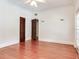 A bright bedroom with hardwood floors featuring sconces and doors to other rooms at 4521 W Azeele St, Tampa, FL 33609