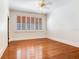 Sunny bedroom features a ceiling fan, hardwood floors, and generous natural light at 4521 W Azeele St, Tampa, FL 33609