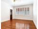 Bright bedroom featuring hardwood floors, a ceiling fan, and a window with white shutters at 4521 W Azeele St, Tampa, FL 33609
