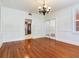 Traditional dining room features hardwood floors, chandelier, and white french doors to an adjoining room at 4521 W Azeele St, Tampa, FL 33609