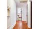 Hallway featuring hardwood floors, white trim, and an open view into a bathroom at 4521 W Azeele St, Tampa, FL 33609