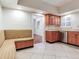 Bright kitchen features stainless steel appliances, wood cabinets, a window, a banquet, and tile floors at 4521 W Azeele St, Tampa, FL 33609