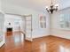 Sun-filled living room showcasing refinished hardwood floors and decorative molding at 4521 W Azeele St, Tampa, FL 33609