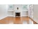 Cozy living room with hardwood floors, fireplace, built-in shelves, and stained glass windows at 4521 W Azeele St, Tampa, FL 33609