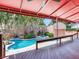 Covered patio overlooking a pool and landscaped backyard with a spa at 4521 W Azeele St, Tampa, FL 33609