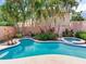 A private backyard oasis with a swimming pool, spa, and lush tropical landscaping at 4521 W Azeele St, Tampa, FL 33609
