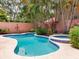Beautiful pool and spa surrounded by lush landscaping, creating a tropical backyard retreat at 4521 W Azeele St, Tampa, FL 33609