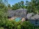Aerial view of the home showcasing the screened pool and spa along with the balcony on the second floor at 4611 Ackerly Way, Brandon, FL 33511