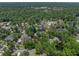 Aerial view of a home nestled among lush greenery in a serene residential neighborhood at 4611 Ackerly Way, Brandon, FL 33511