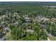 Aerial view of a home with mature tree coverage, water view, and neighborhood streets at 4611 Ackerly Way, Brandon, FL 33511