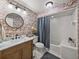 This bathroom features a shower-tub combo and a vanity with marble countertops at 4611 Ackerly Way, Brandon, FL 33511